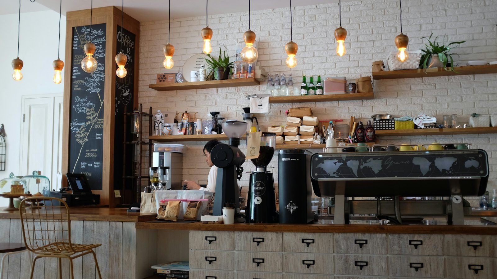 Coffee bar with an espresso machine and shelves of cups